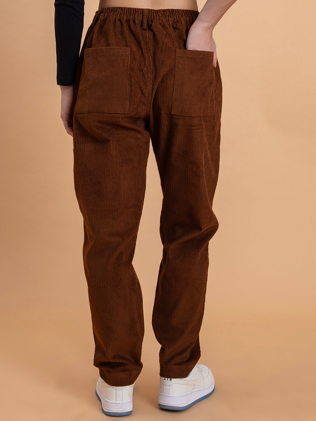 Close-up of corduroy fabric texture on brown baggy trousers