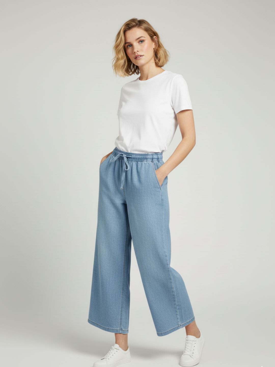Side view of light blue denim trousers with side pockets