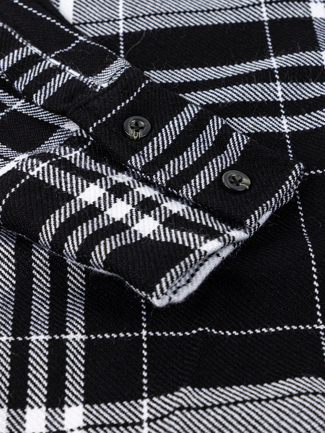 Black and white tartan shirt styled with denim trousers