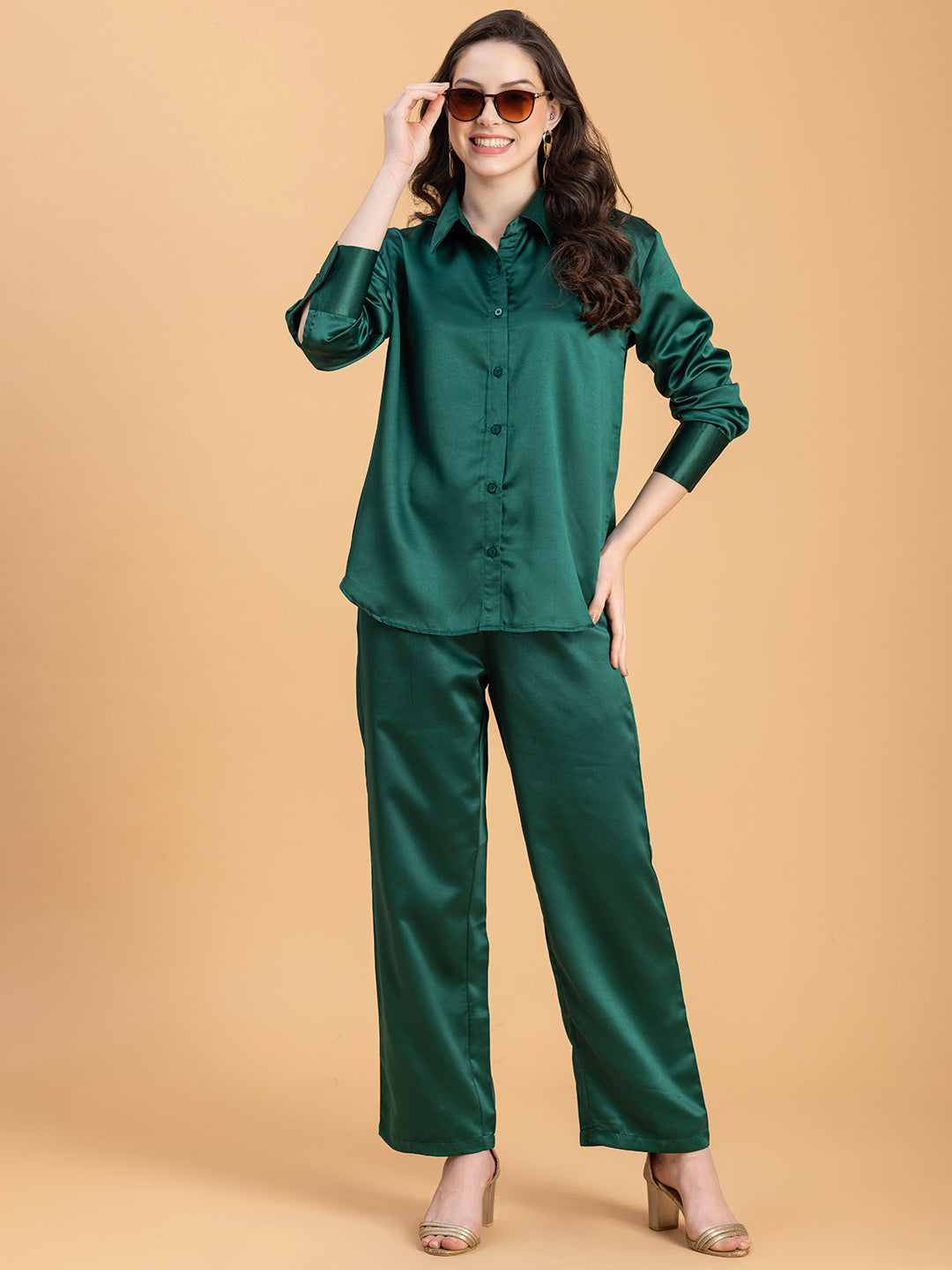 Lifestyle shot of woman in dark green satin co-ord