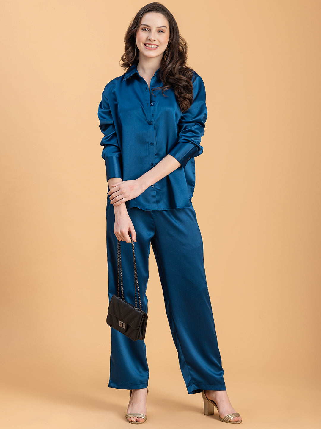 Lifestyle shot of woman in navy satin co-ord