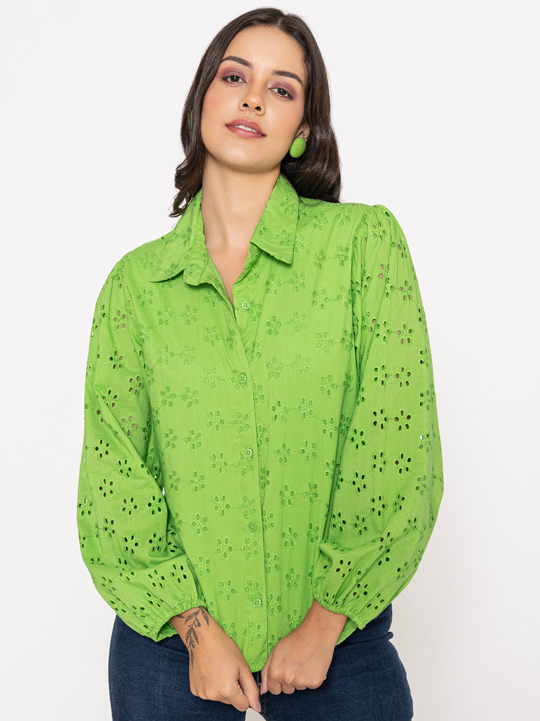 Close-up of Schiffli embroidery on lime green cotton shirt