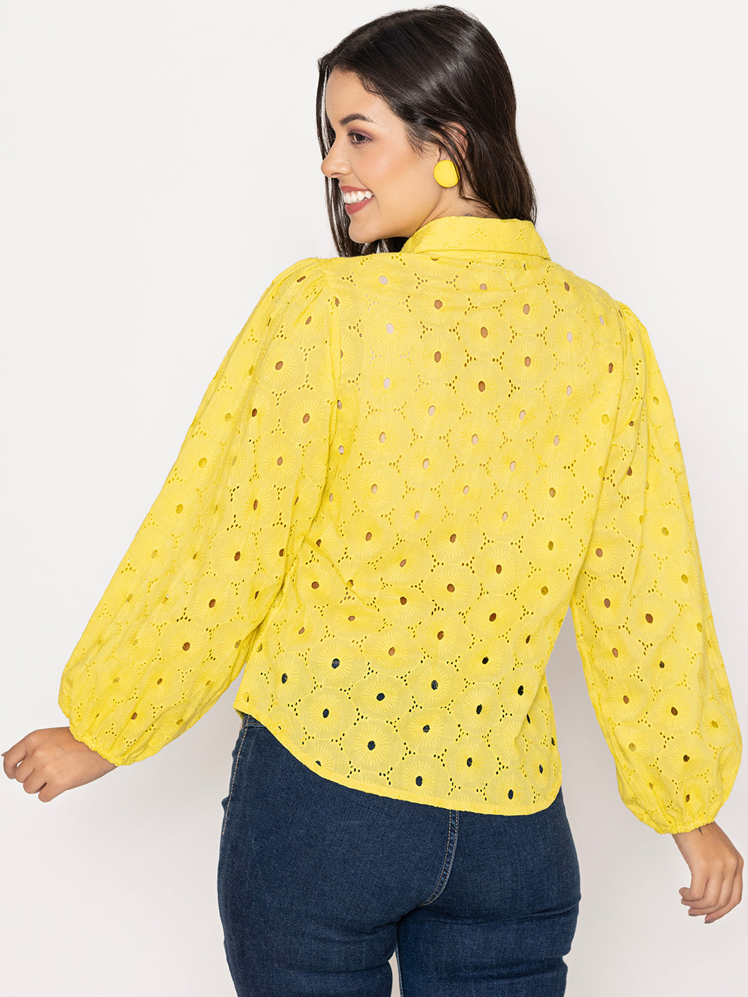 Close-up of Schiffli embroidery on yellow cotton shirt