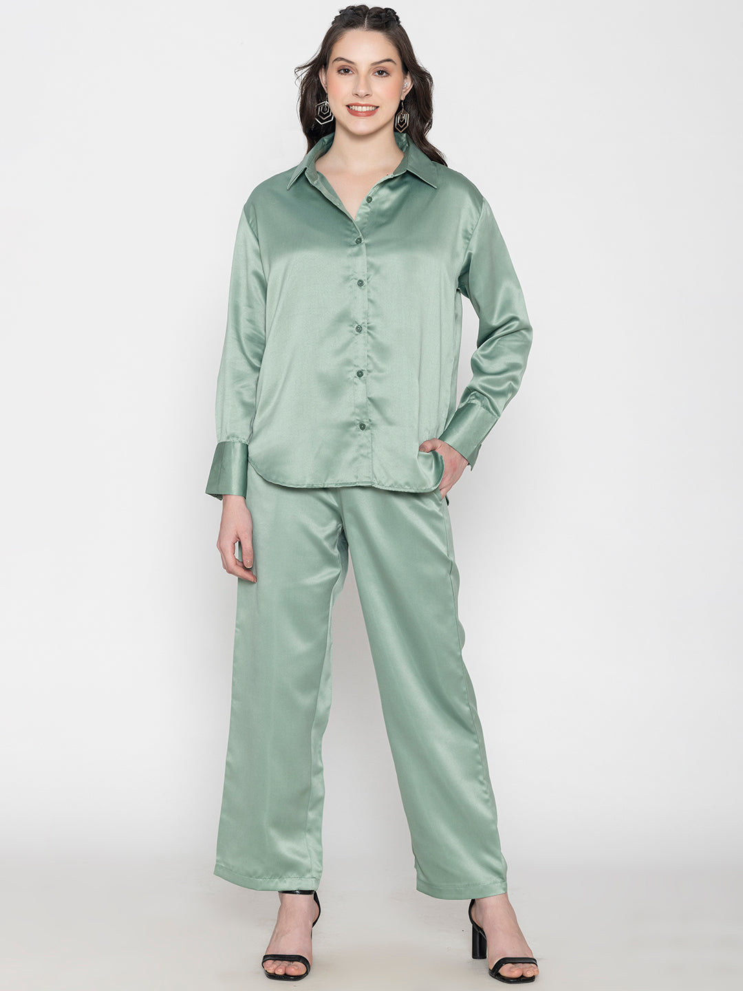 Lifestyle shot of woman in light green satin co-ord