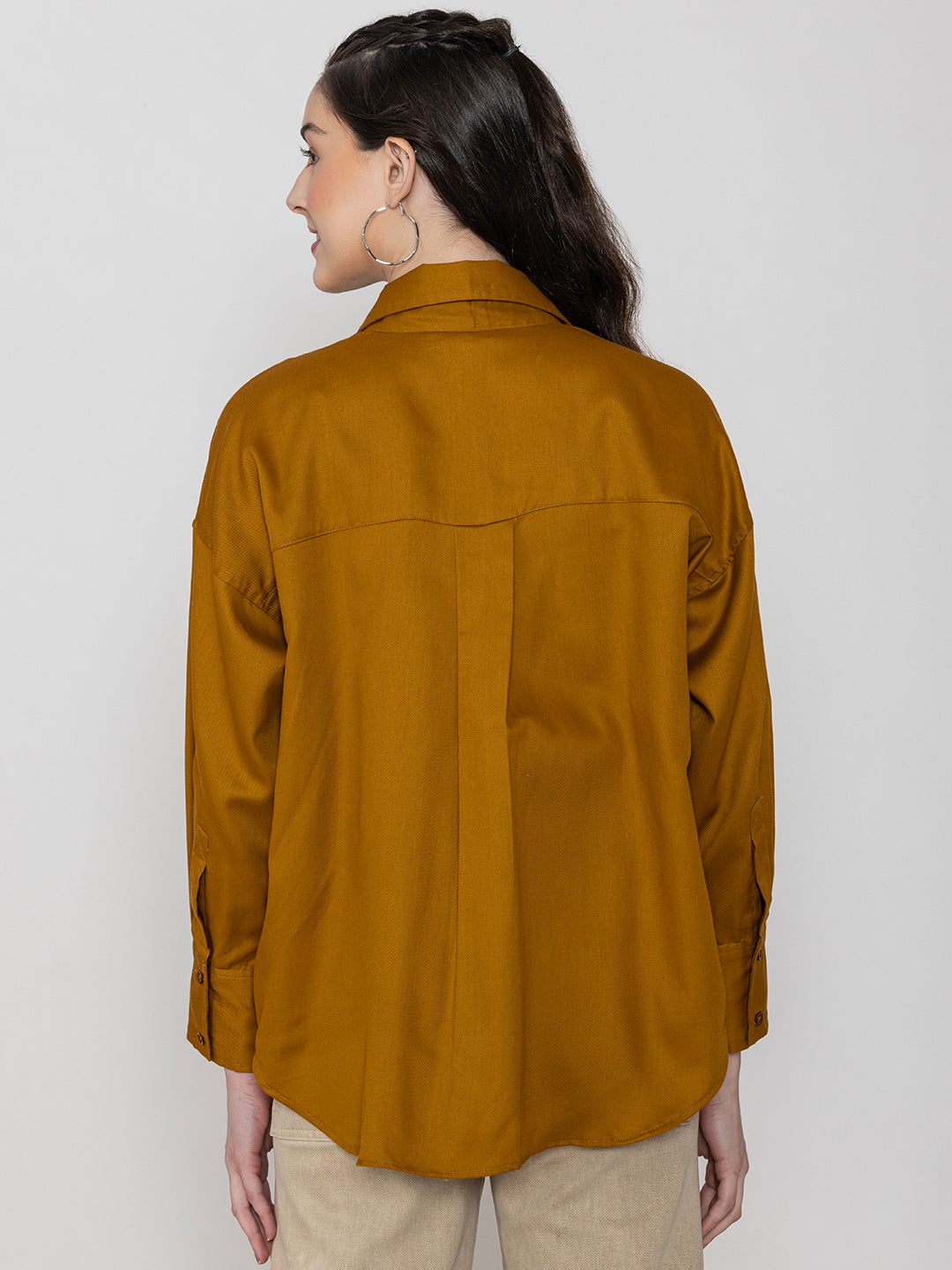 Detail of buttoned cuffs on brown twill shirt