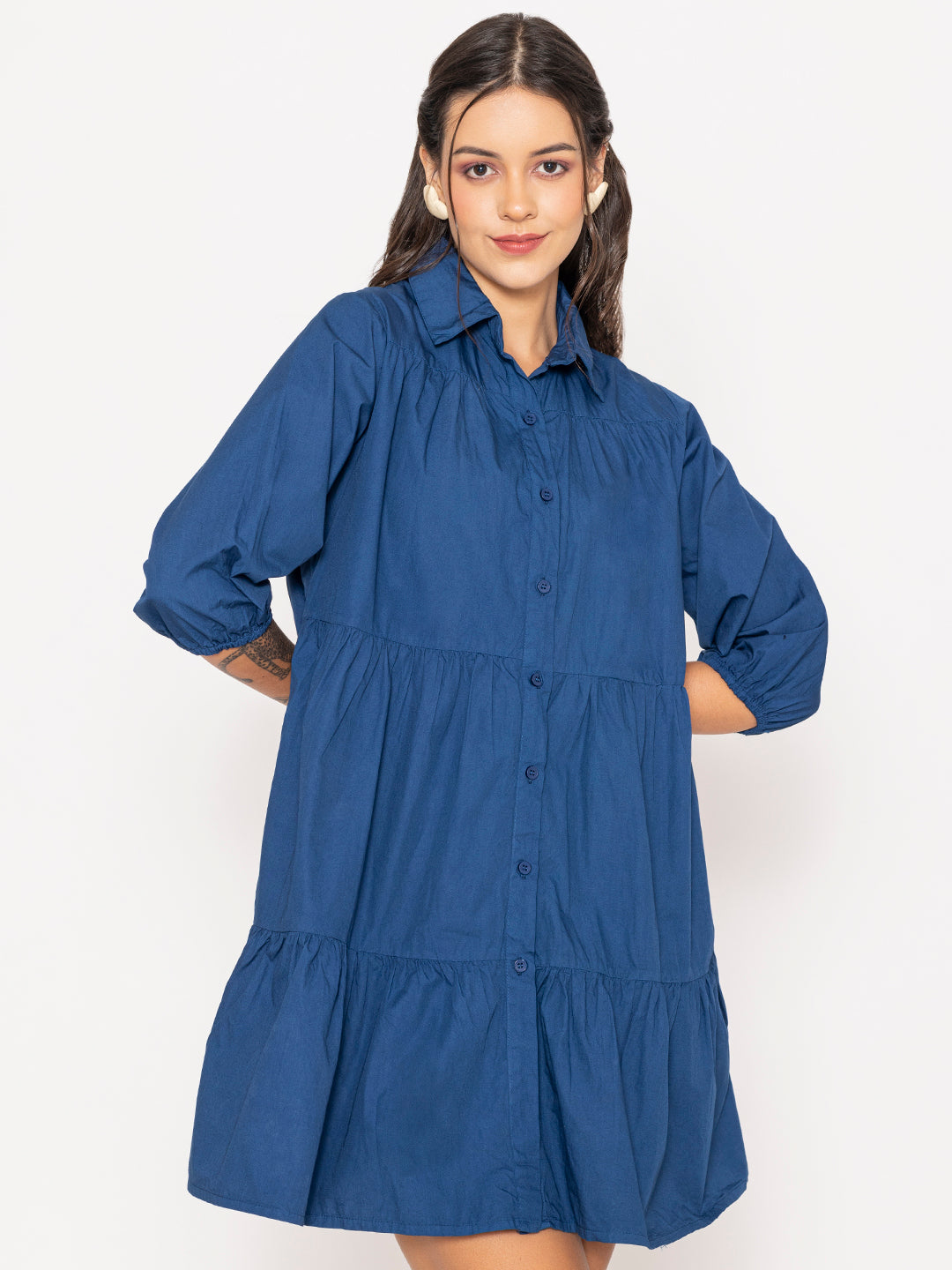 Button placket detail on blue cotton shirt dress