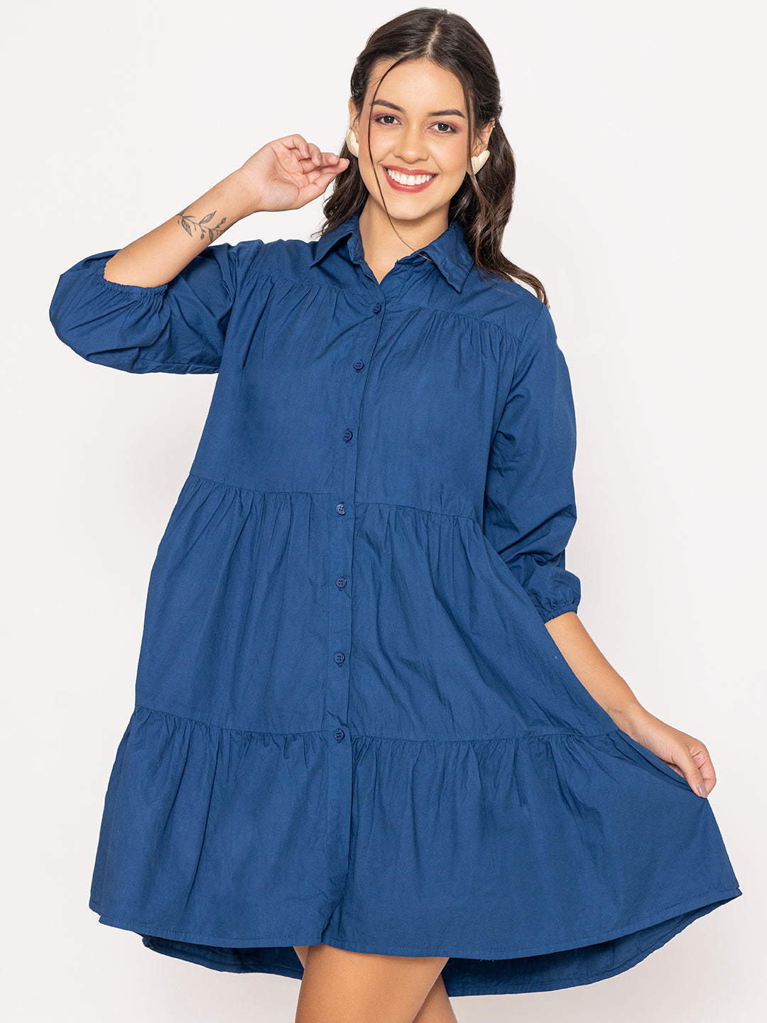Lifestyle shot of woman wearing blue cotton shirt dress