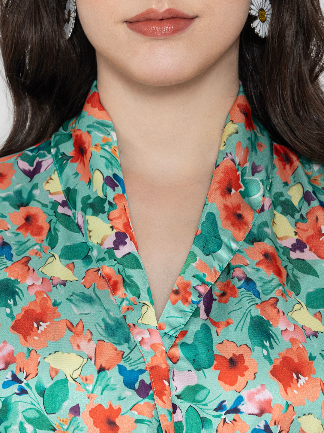 Close-up of green floral print satin fabric