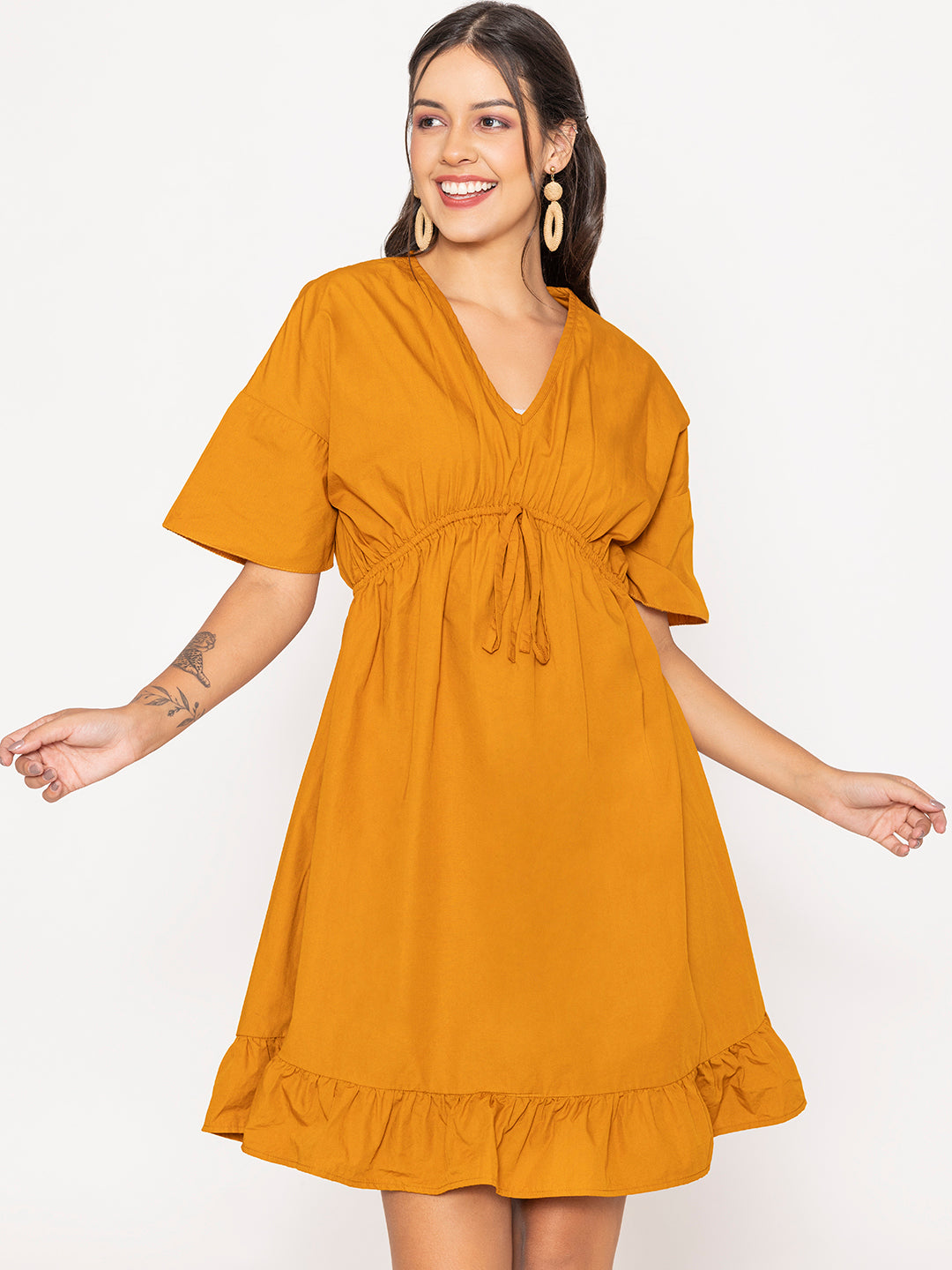 Close-up of V-neckline on tan brown cotton dress