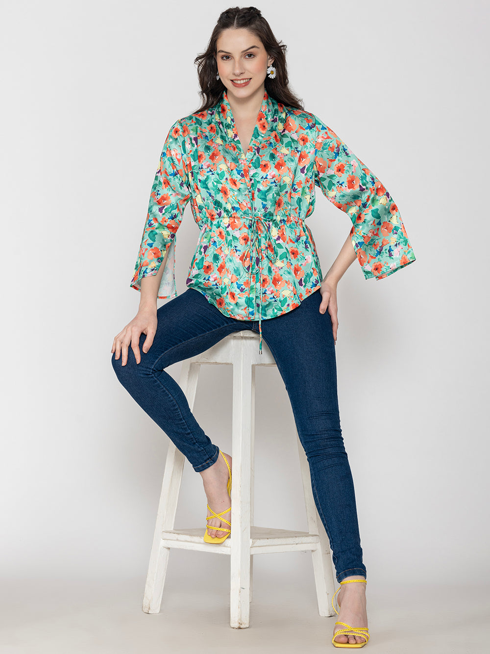 Side view of green floral satin top with long buttoned cuffs