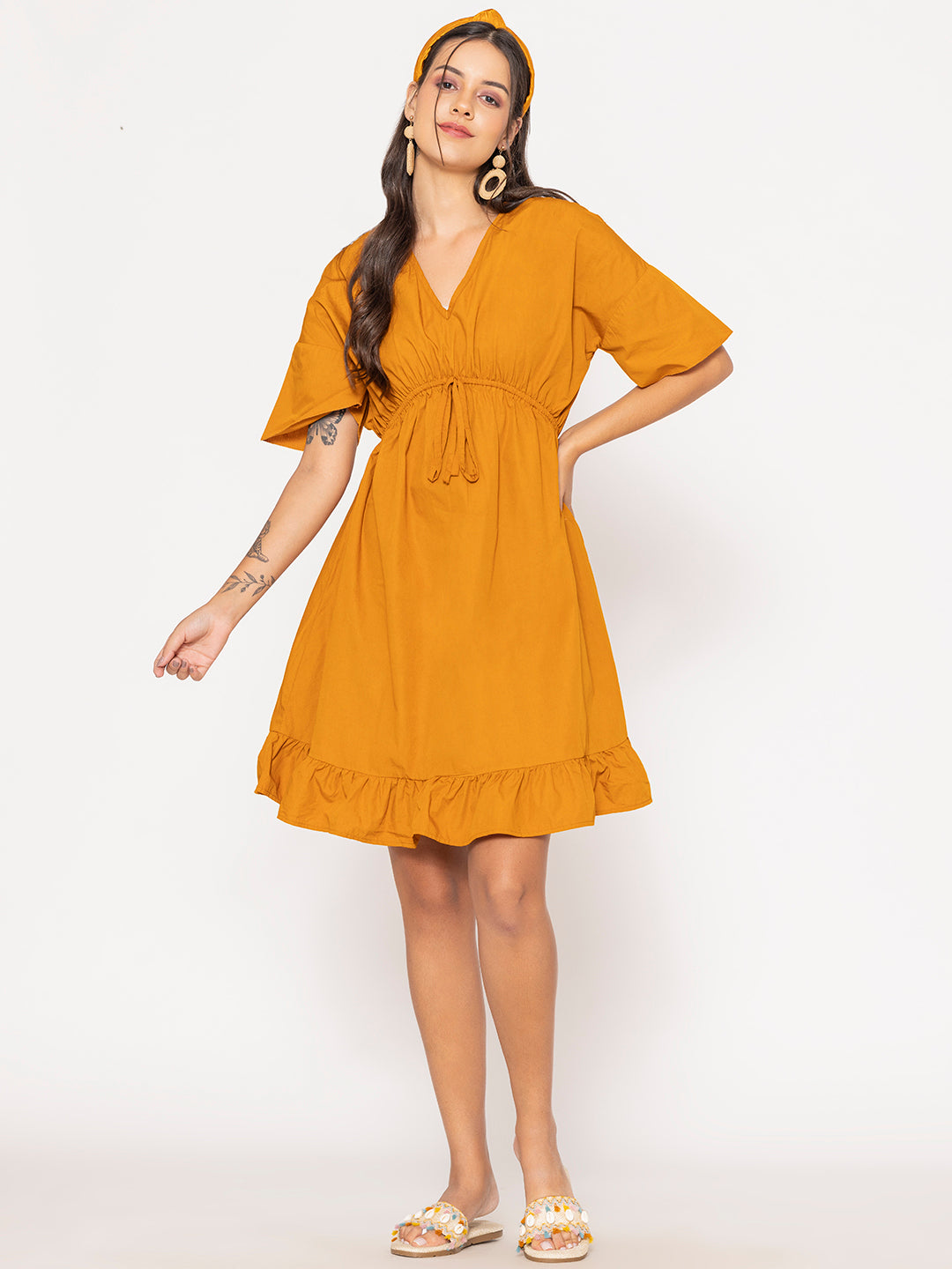 Hem detail of tan brown cotton dress