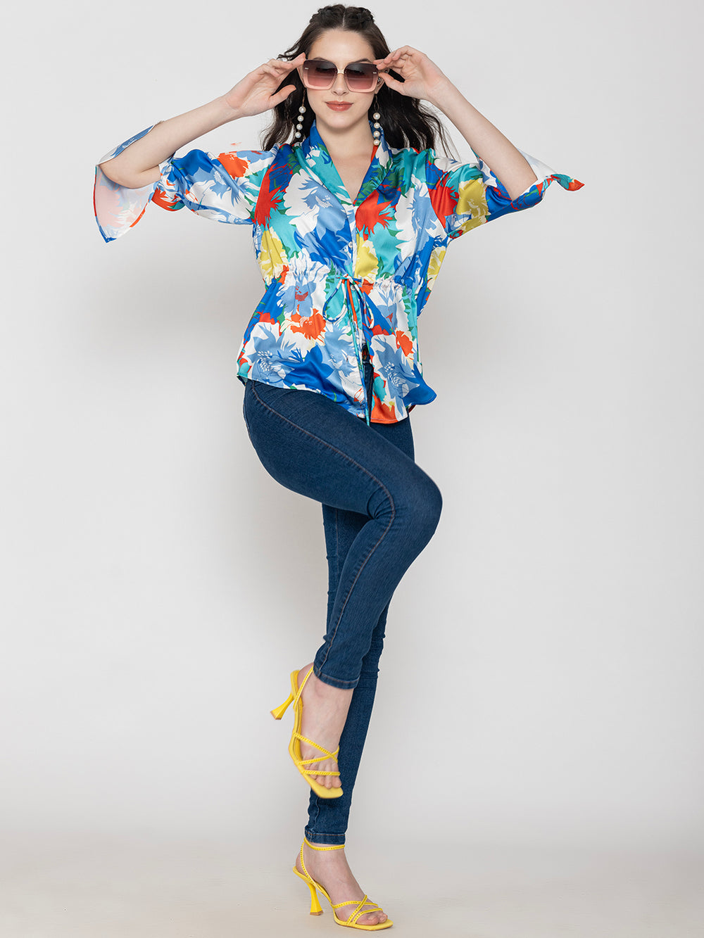 Side view of blue floral satin top with long buttoned cuffs