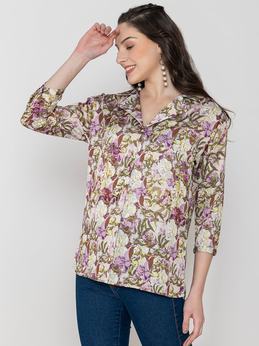 Lifestyle shot of purple floral satin top styled with denim