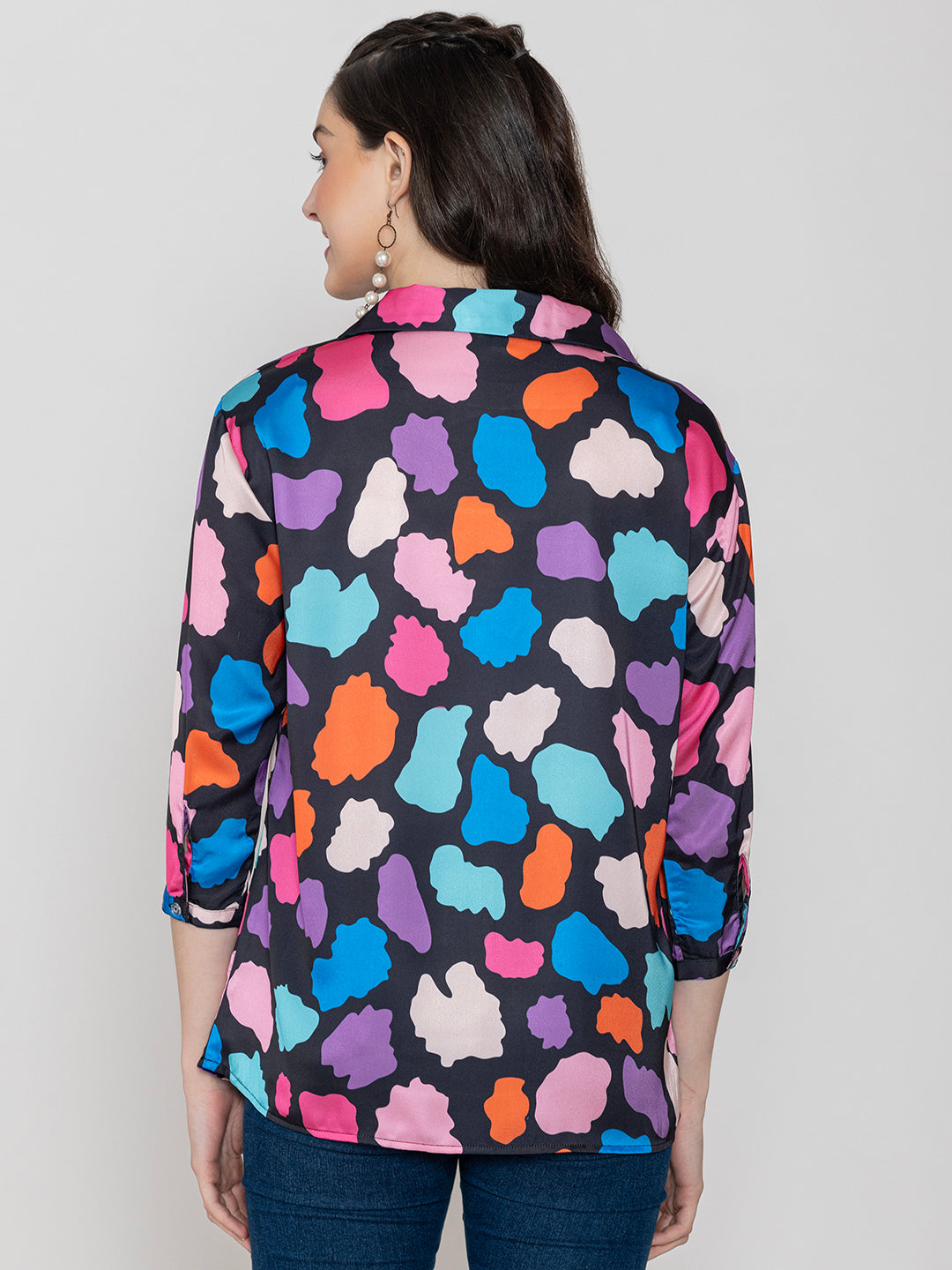Lifestyle shot of multi print satin top styled with denim