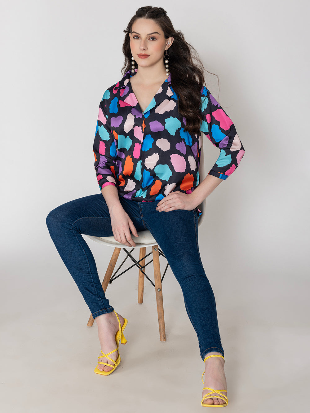 Side view of multi print satin top with long buttoned cuffs