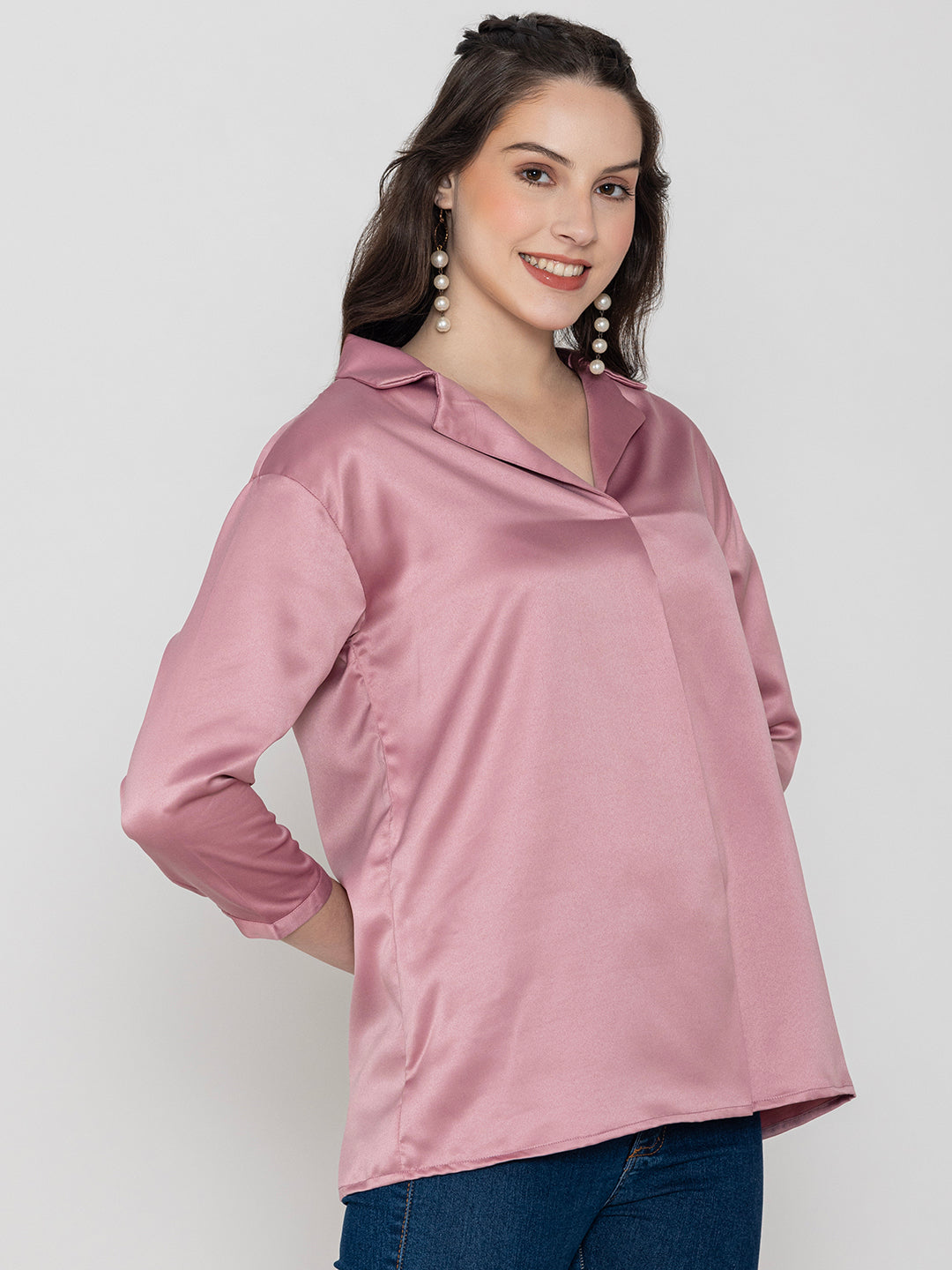 Lifestyle shot of light pink satin top styled