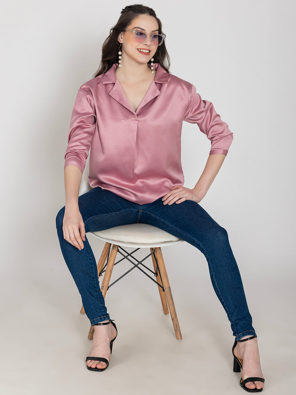 Side view of light pink satin top with long buttoned cuffs