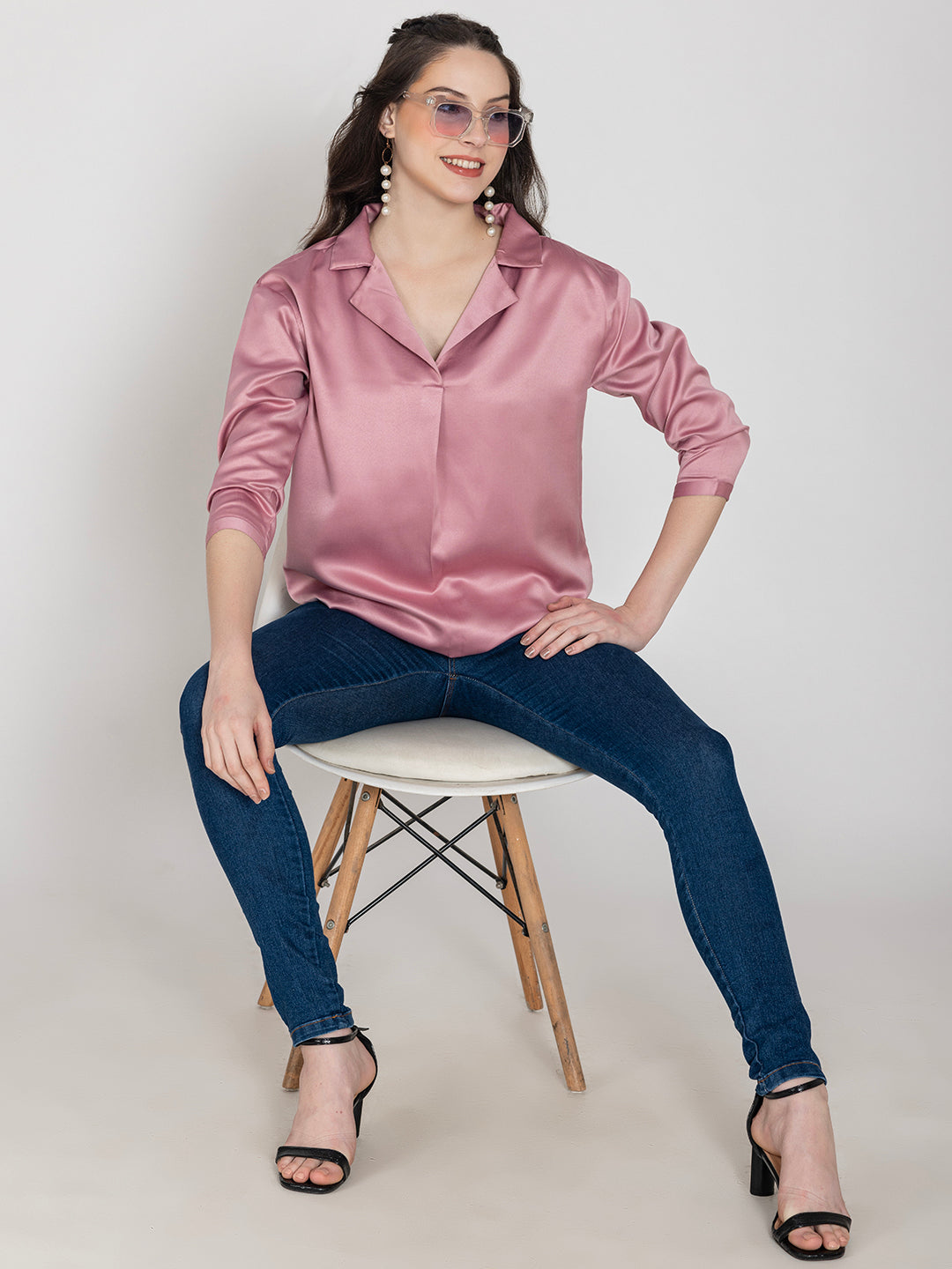 Side view of light pink satin top with long buttoned cuffs