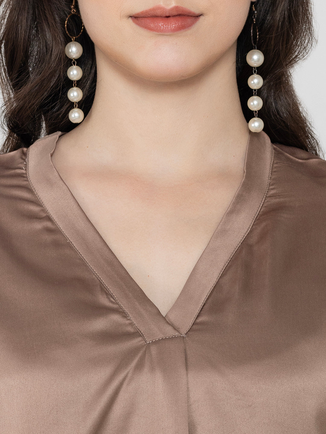 Close-up of beige satin V-neck detail
