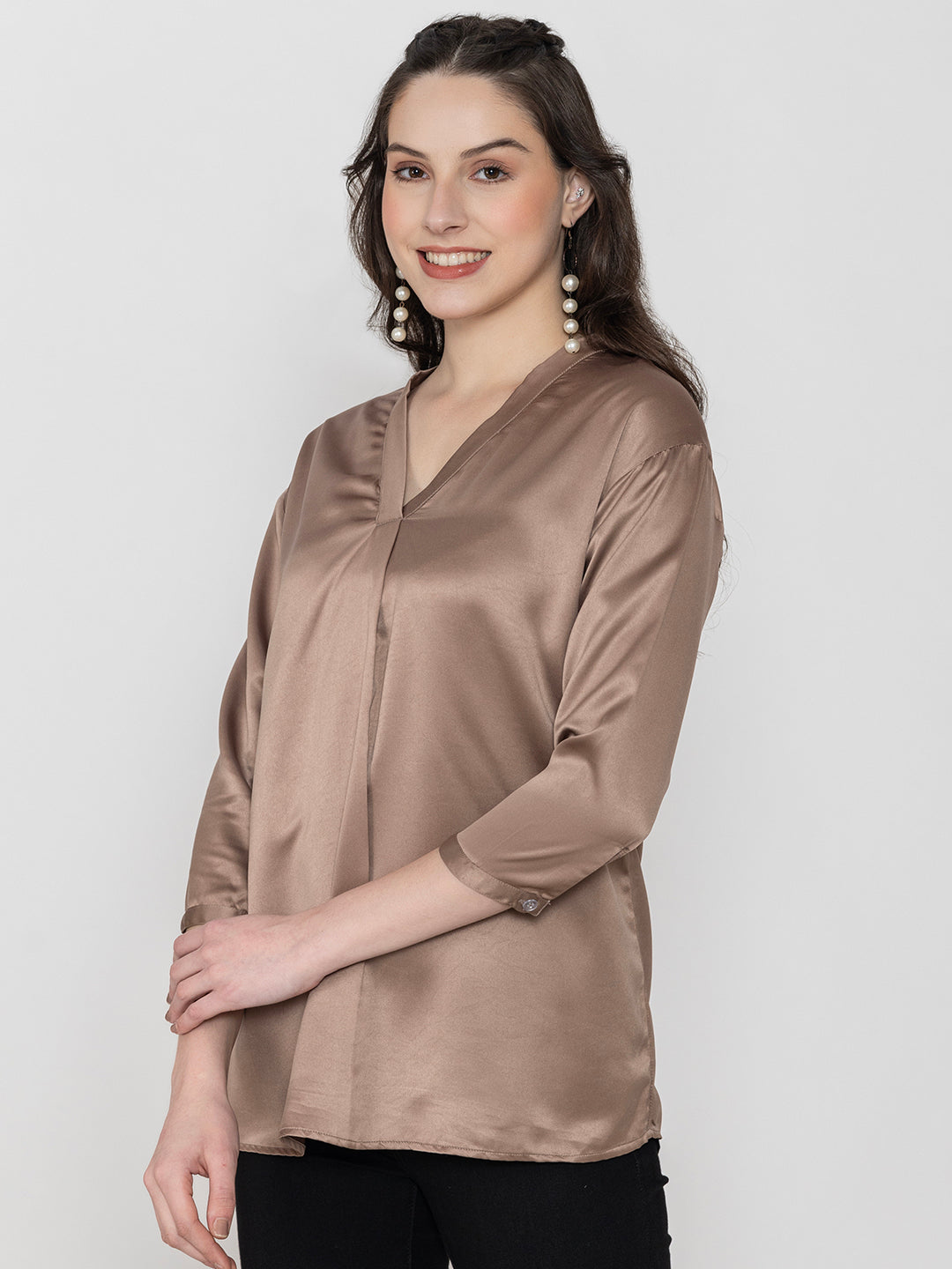 Lifestyle shot of woman in beige satin top