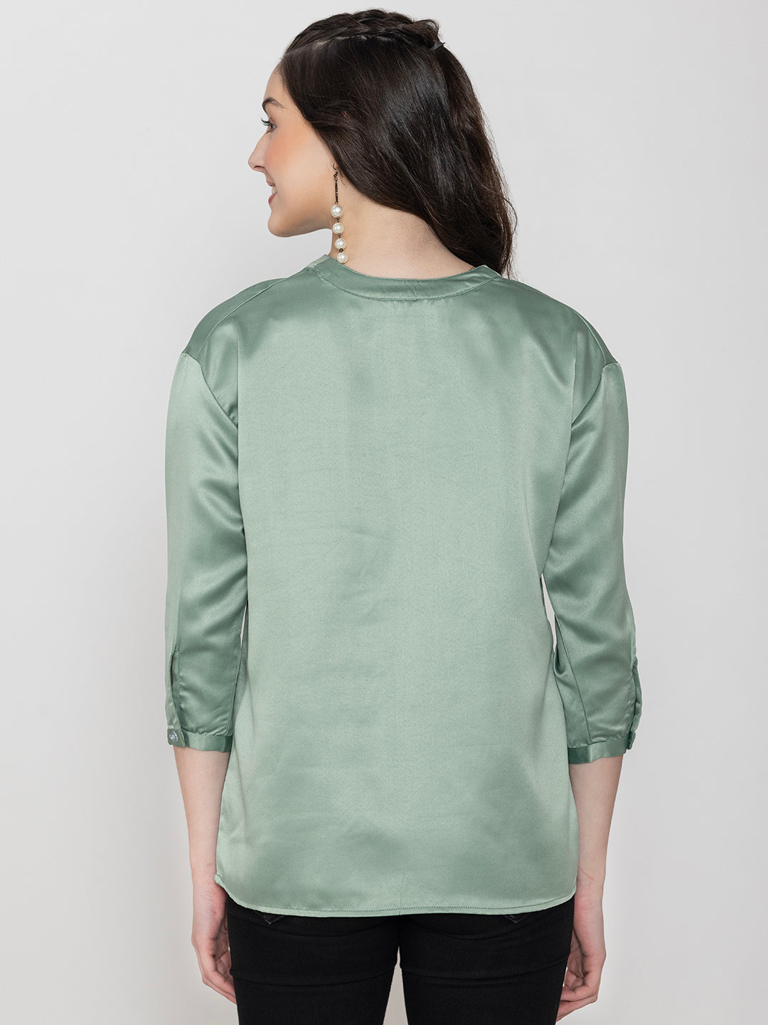 Close-up of light green satin fabric