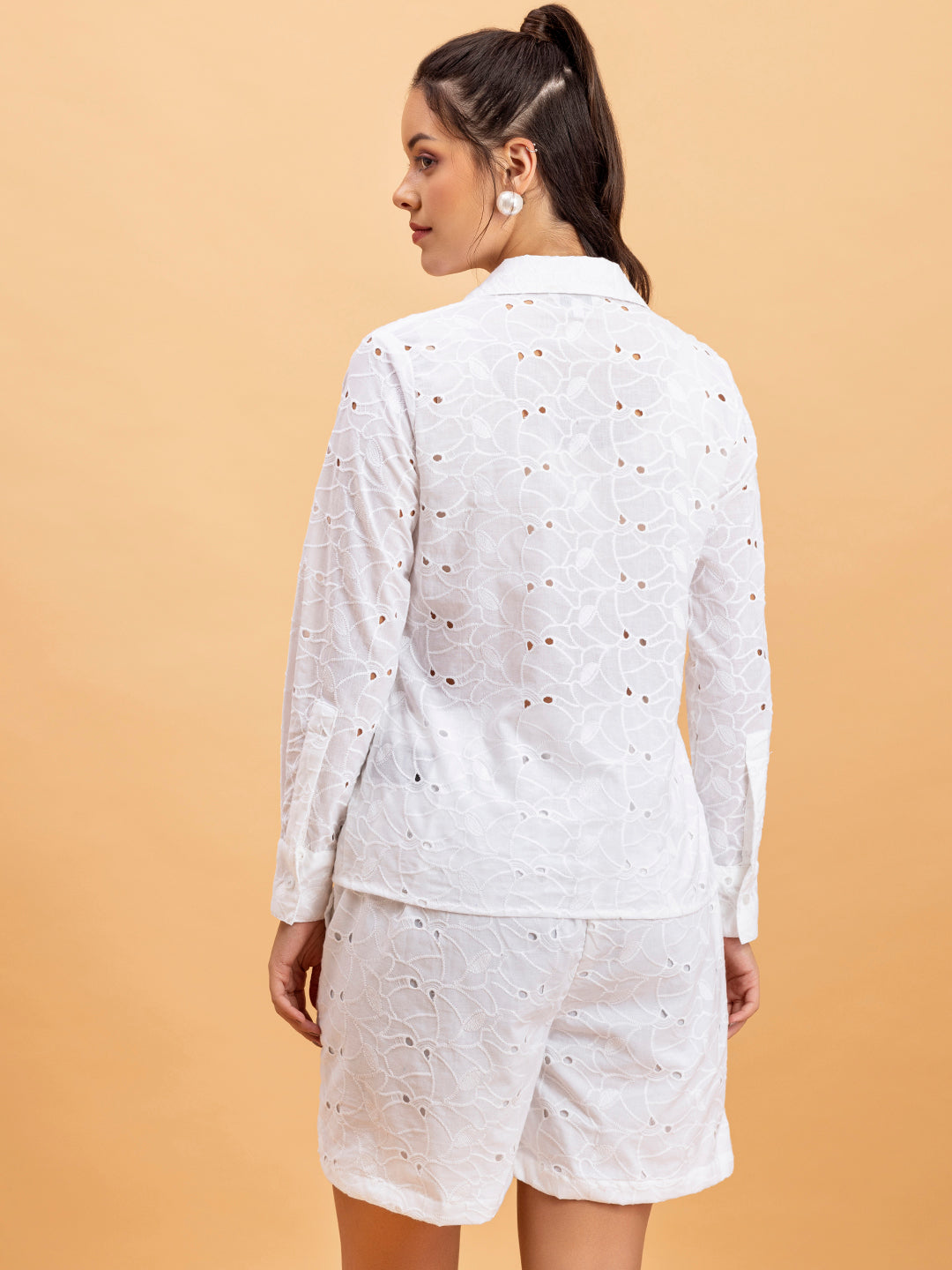 Lifestyle shot of model wearing white cotton shorts co-ord set