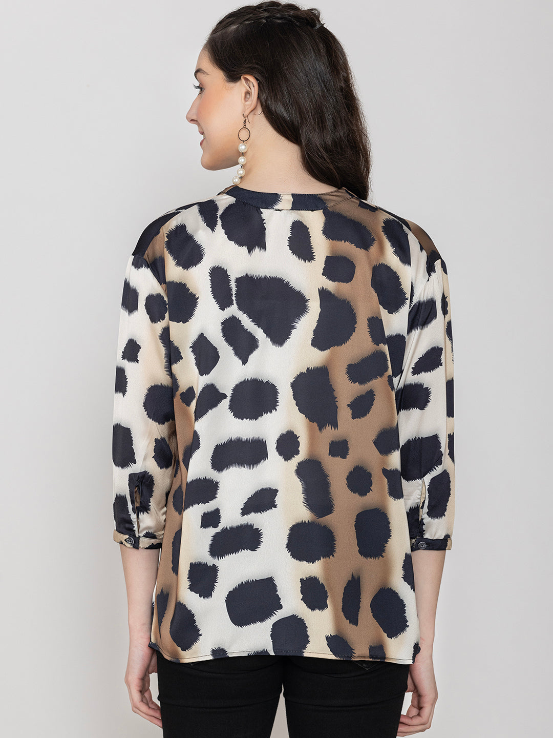 Close-up of beige animal print satin fabric