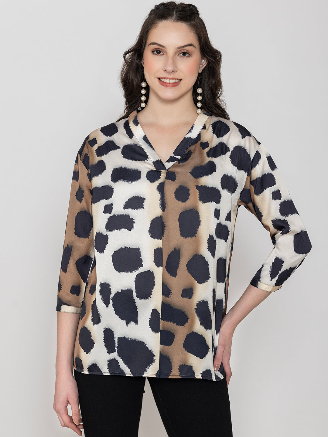 Detail shot of v-neck on beige satin top