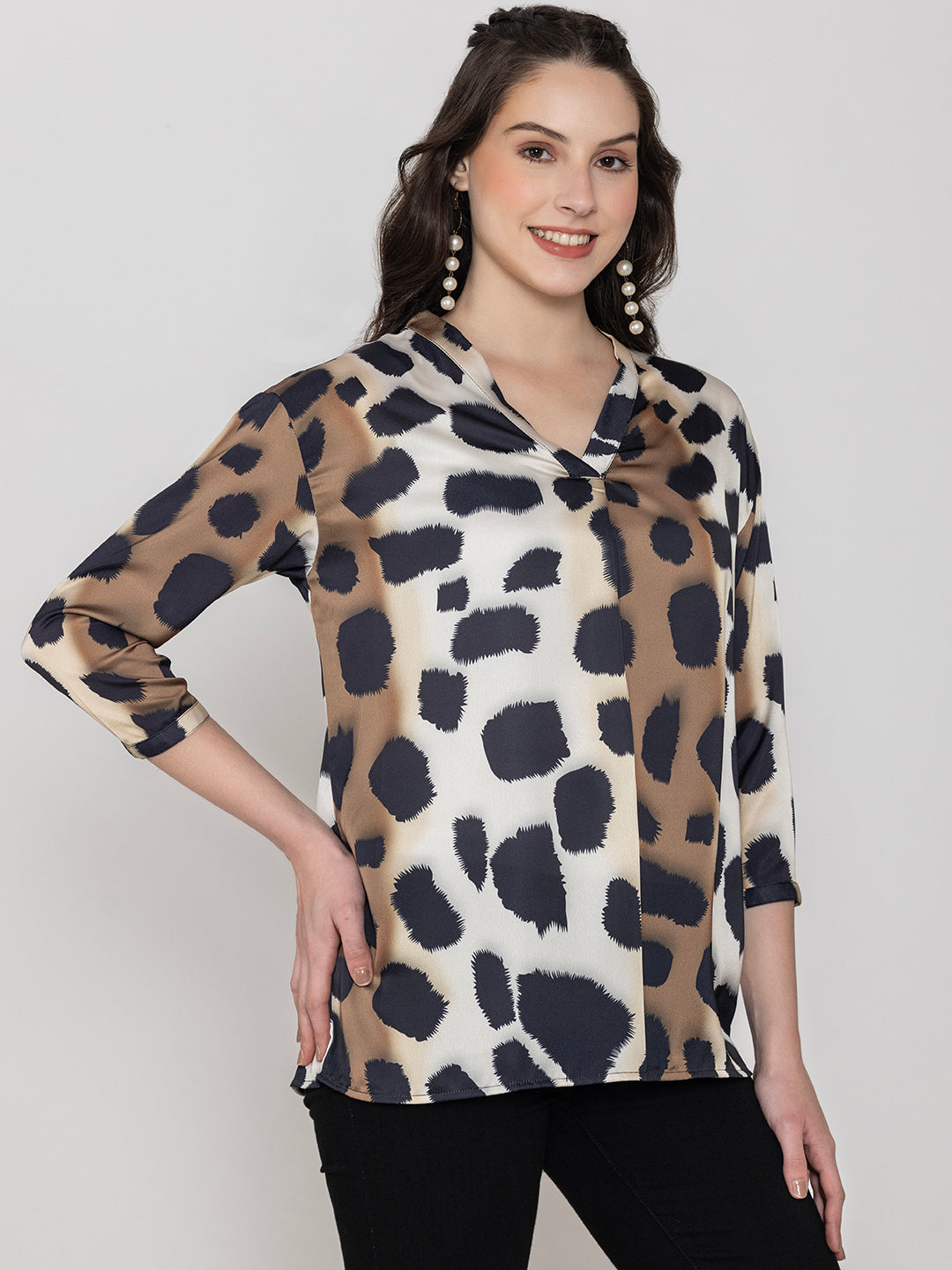 Lifestyle shot of beige animal print satin top styled