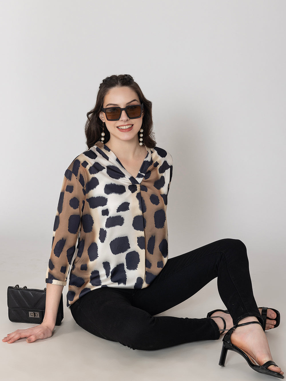Side view of beige animal print satin top