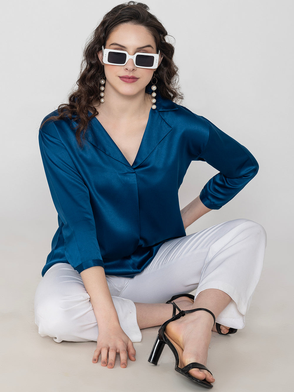 Side view of navy blue satin top with long buttoned cuffs