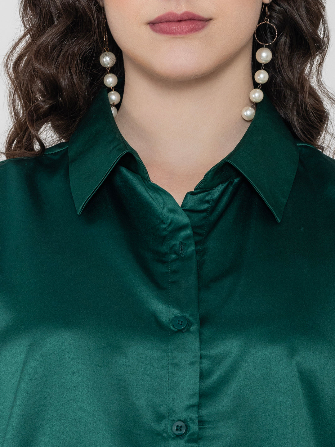 Close-up of dark green satin fabric and collar