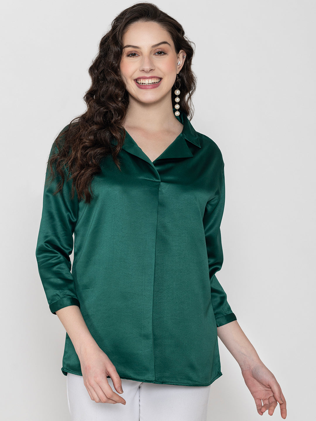 Detail shot of shirt collar on dark green satin top