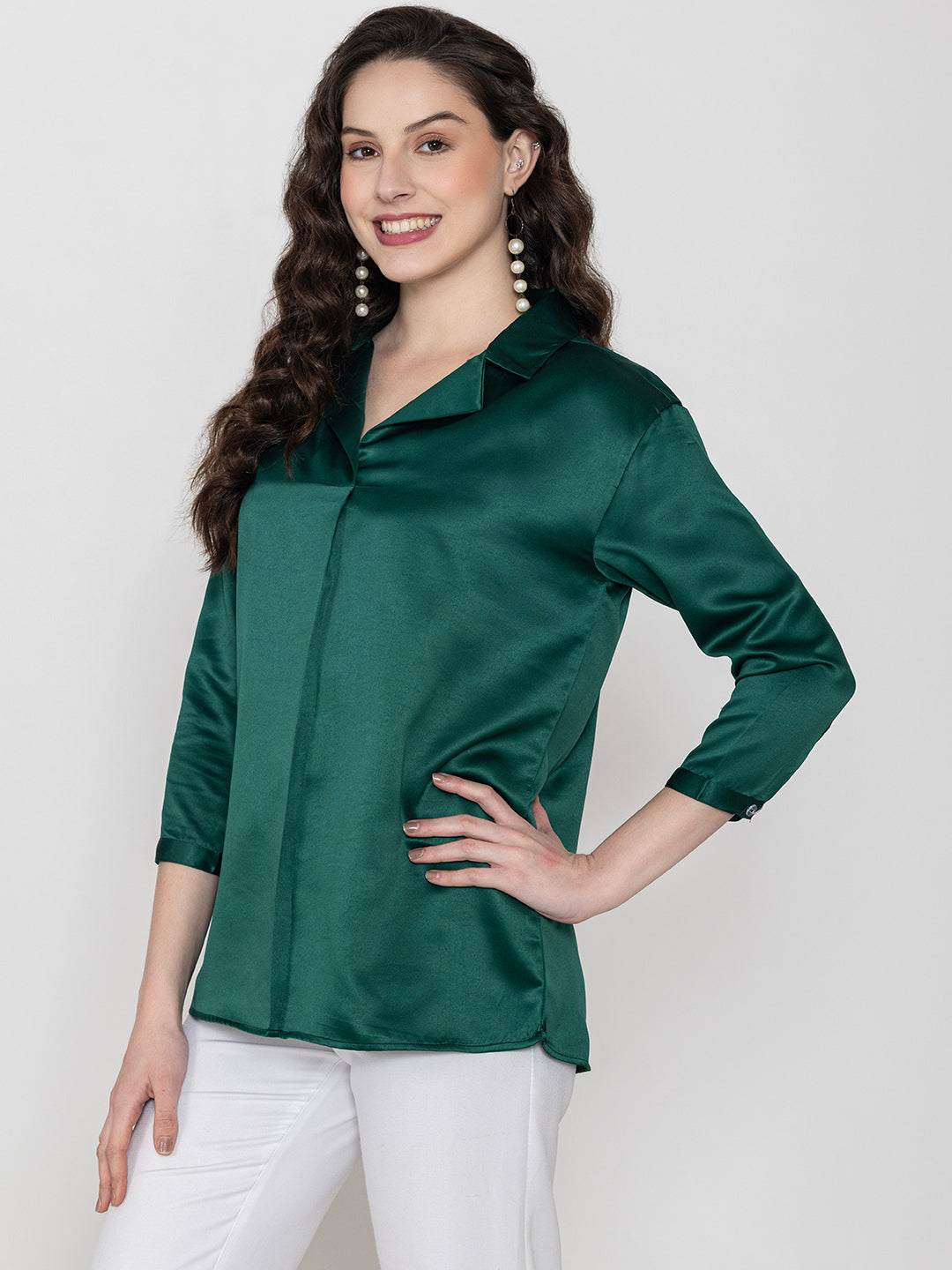 Lifestyle shot of dark green satin top styled