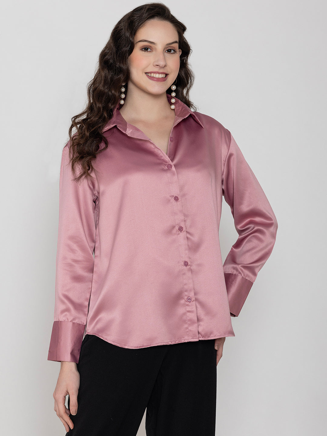 Lifestyle shot of woman in light pink satin shirt