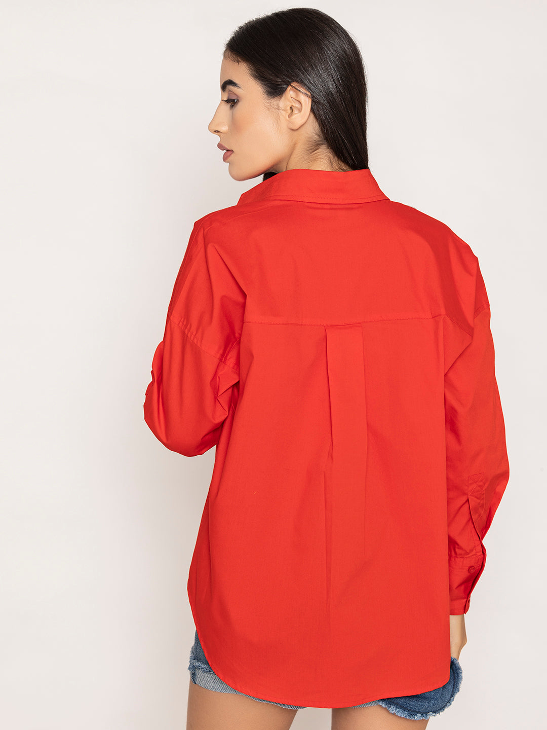 Full outfit shot styled with red oversized poplin shirt