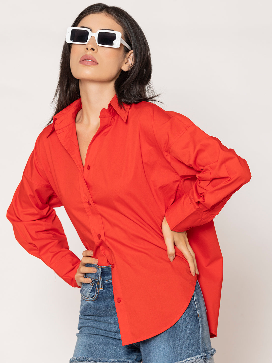 Lifestyle shot of woman wearing red cotton poplin oversized shirt
