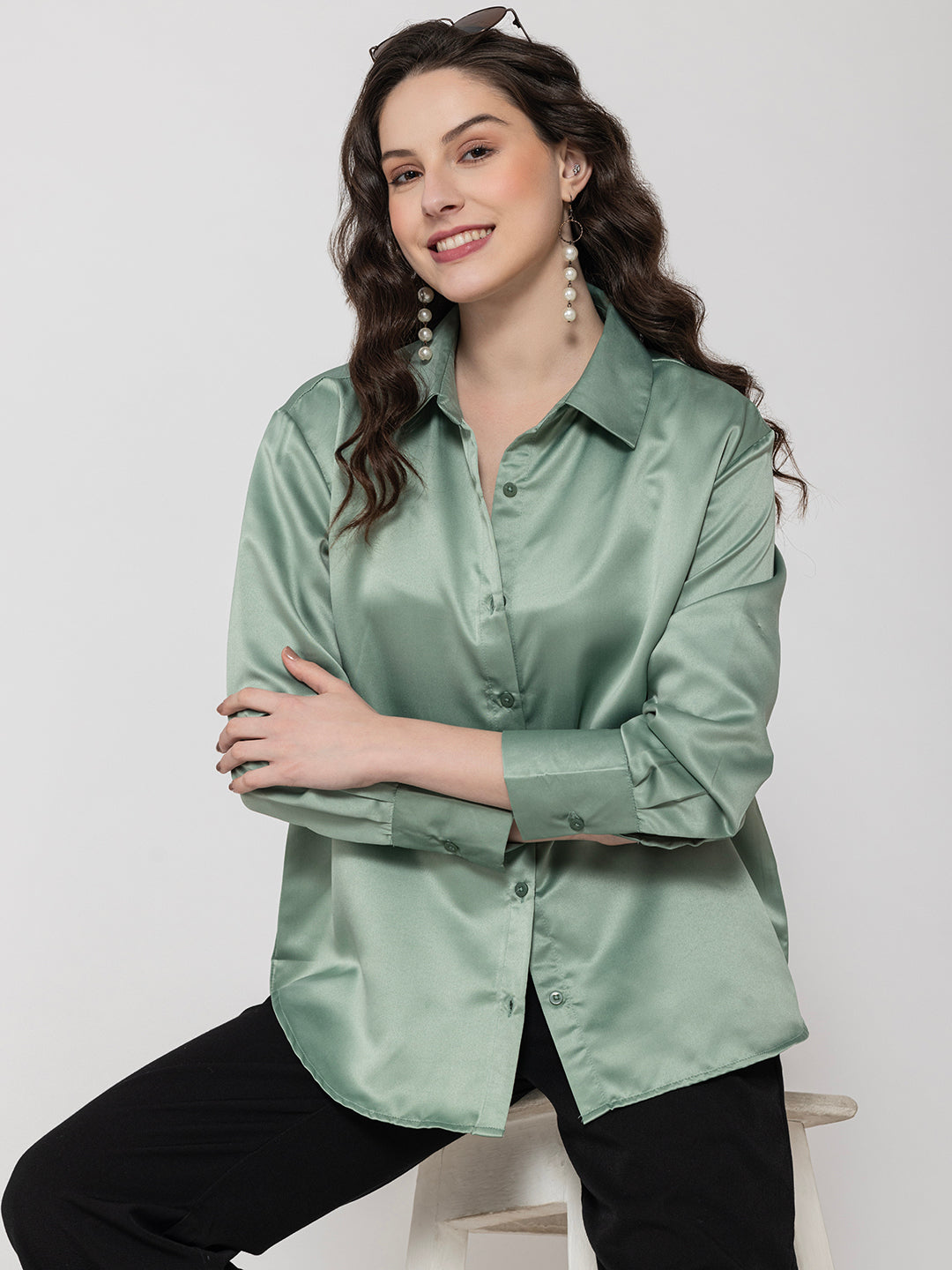 Lifestyle shot of woman in light green satin shirt