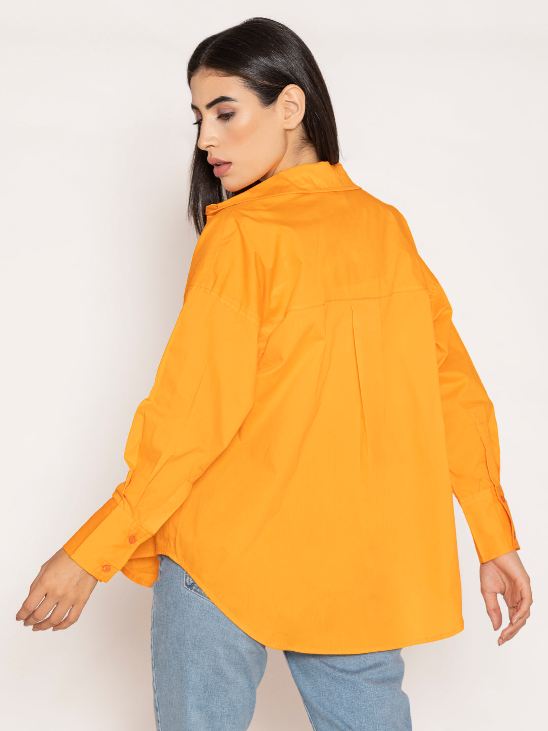 Curved hem detail on orange poplin shirt