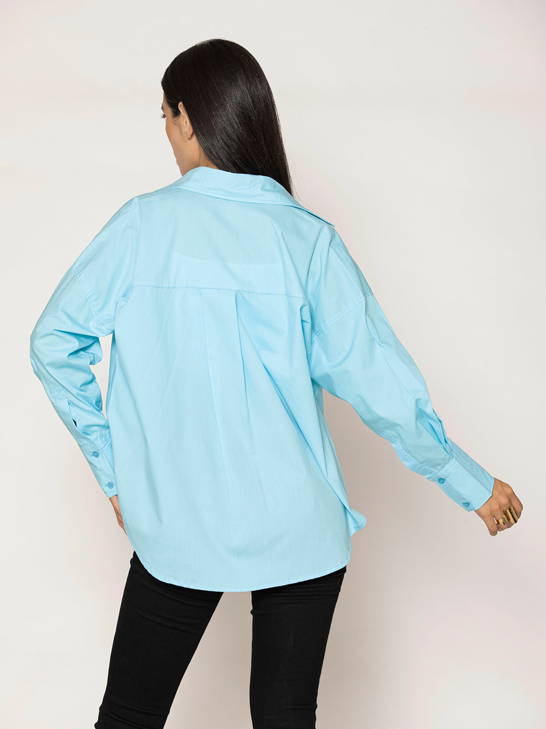 Curved hem detail on sky blue poplin shirt
