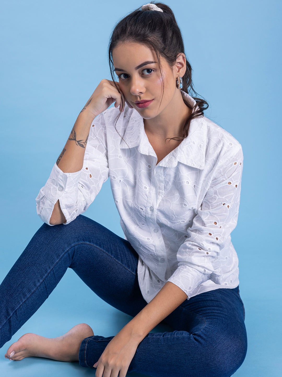 Pocket and embroidery detail on white shirt