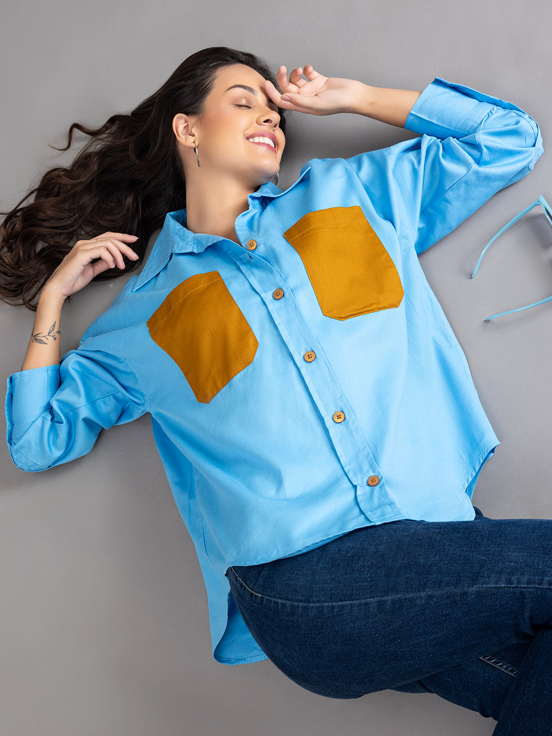 Detail of buttoned cuffs on sky blue twill shirt