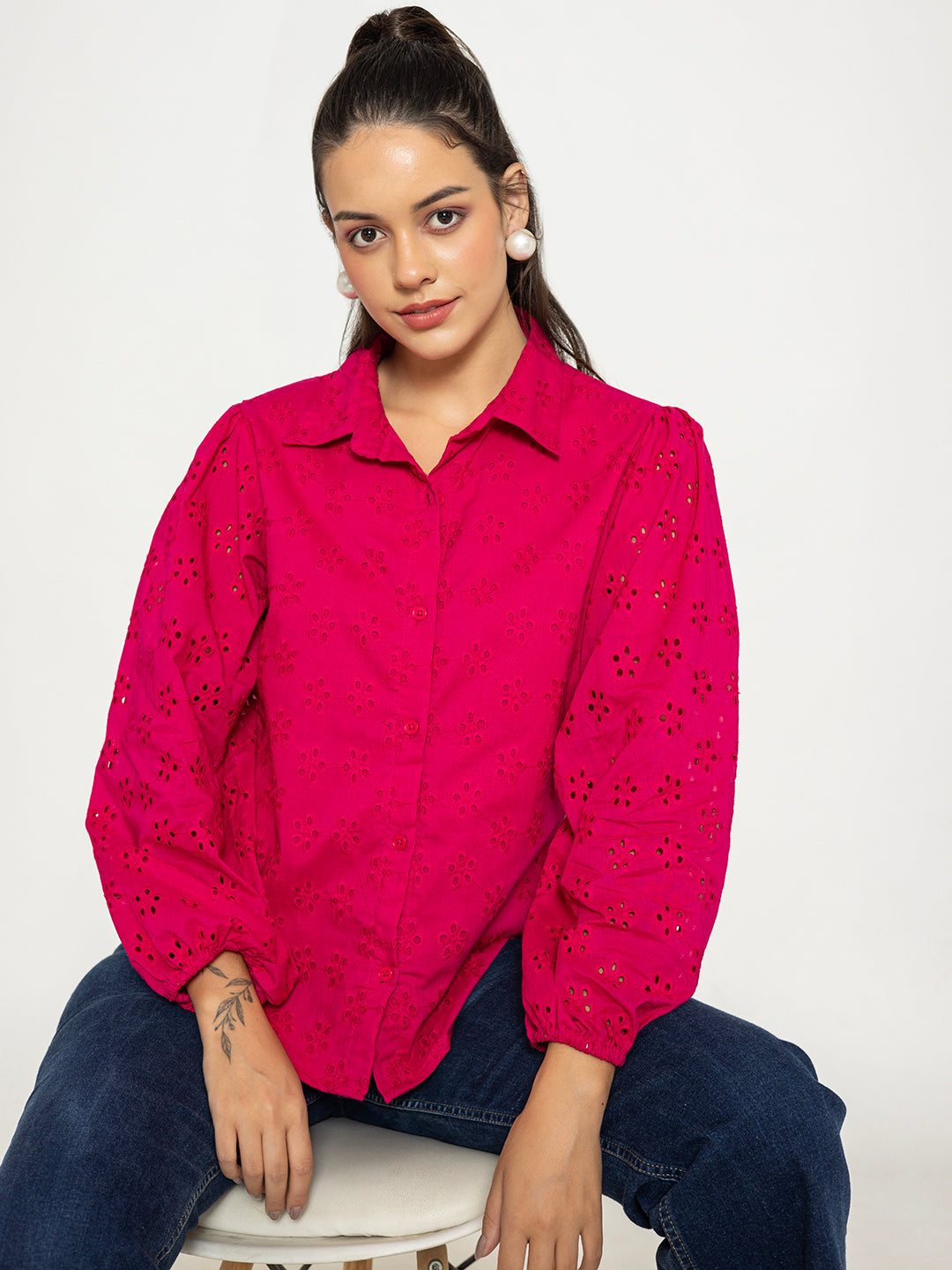 Close-up of Schiffli embroidery on hot pink cotton shirt