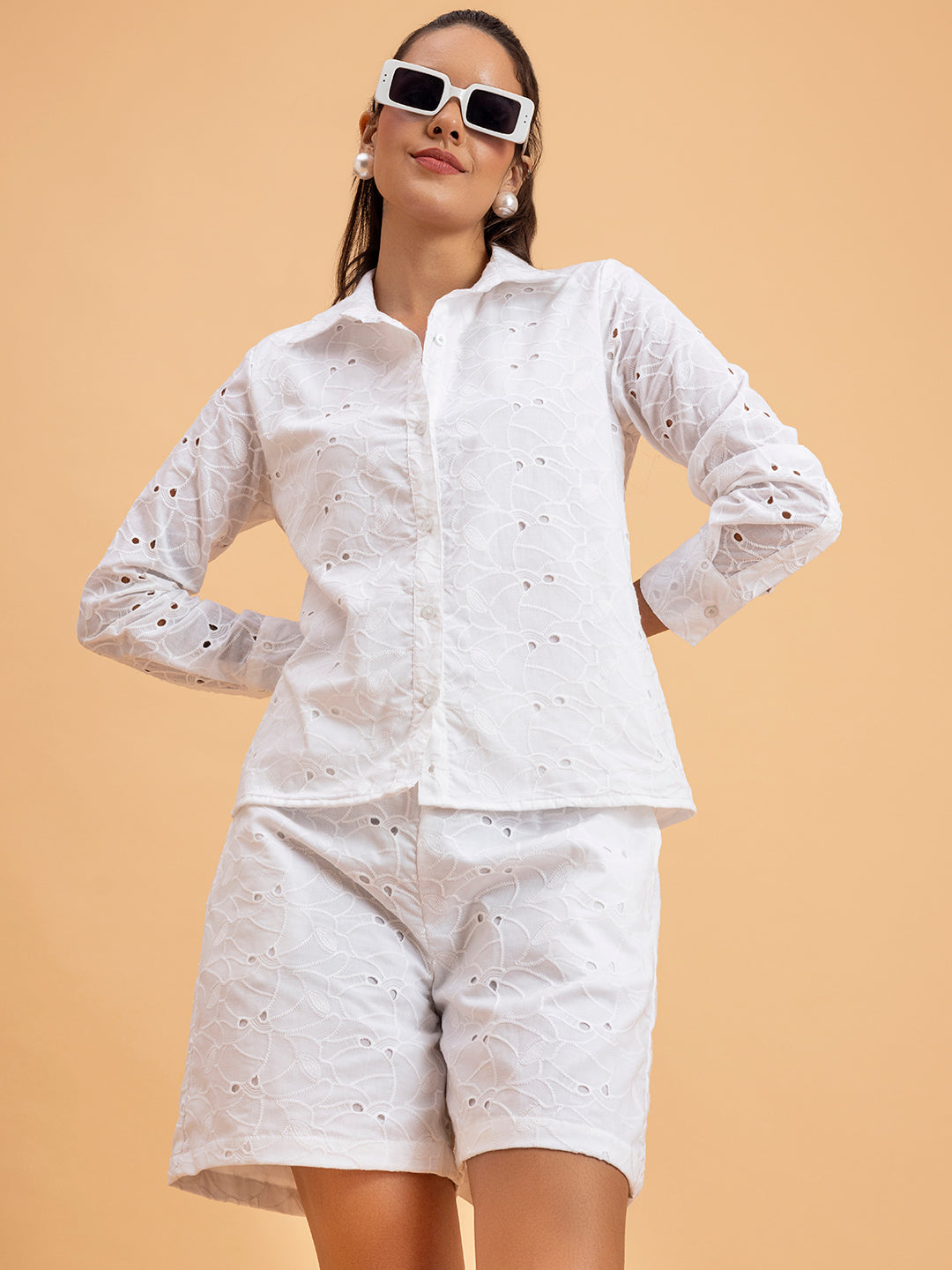 Front view of woman in white schiffli embroidered cotton shorts co-ord set
