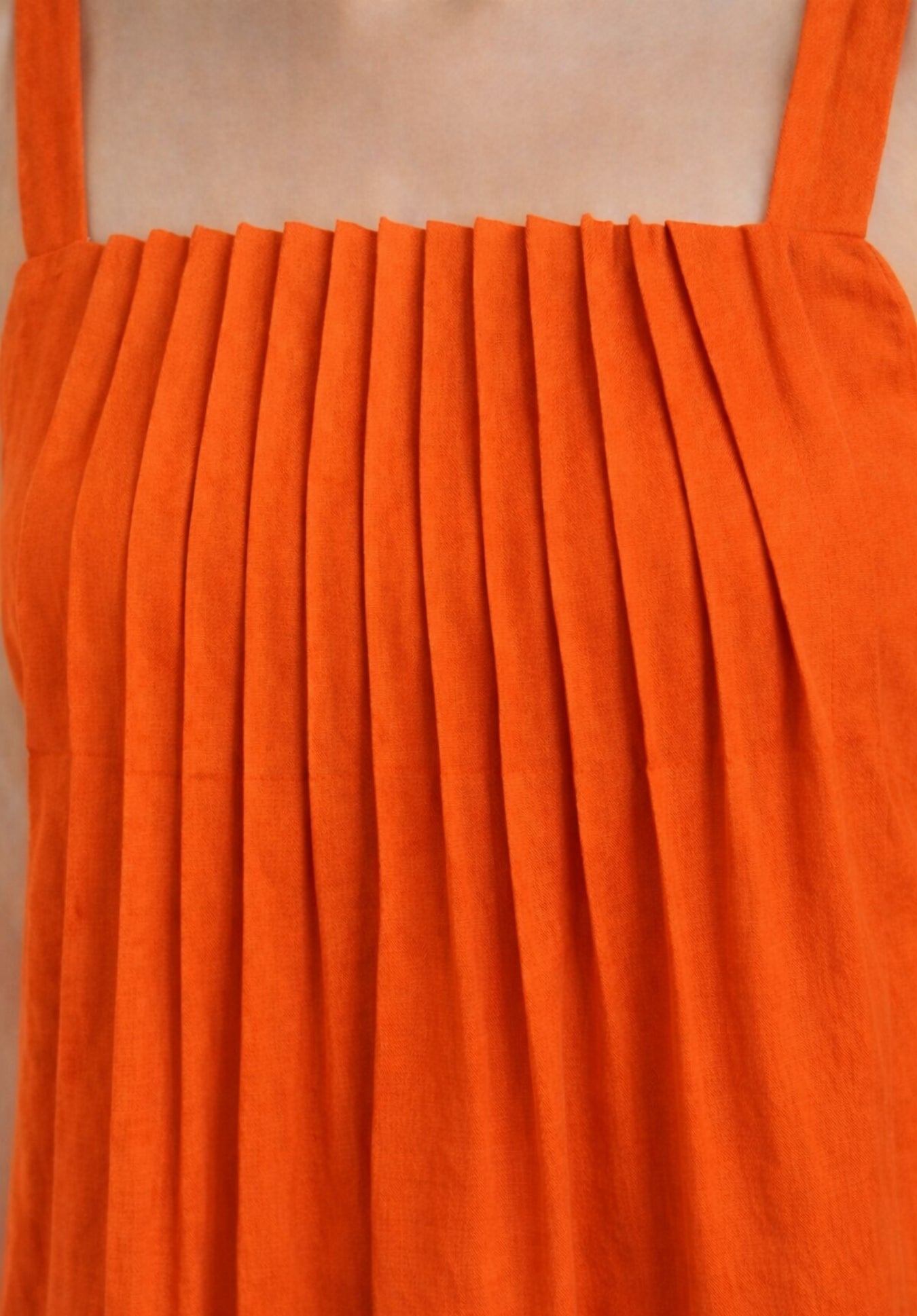 Lifestyle shot of rust cotton A-line midi dress styled with accessories