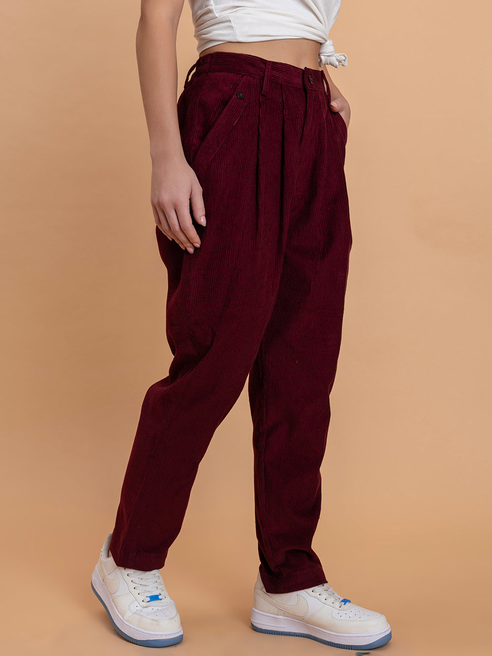 Side view of maroon corduroy relaxed-fit trousers