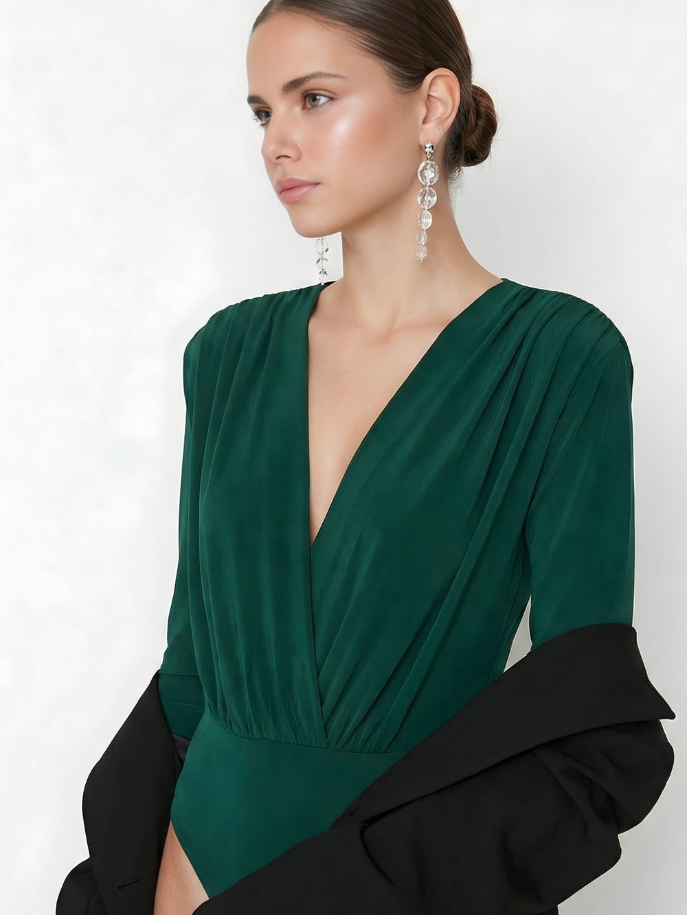 Side angle of green V-neck bodysuit showing fitted silhouette
