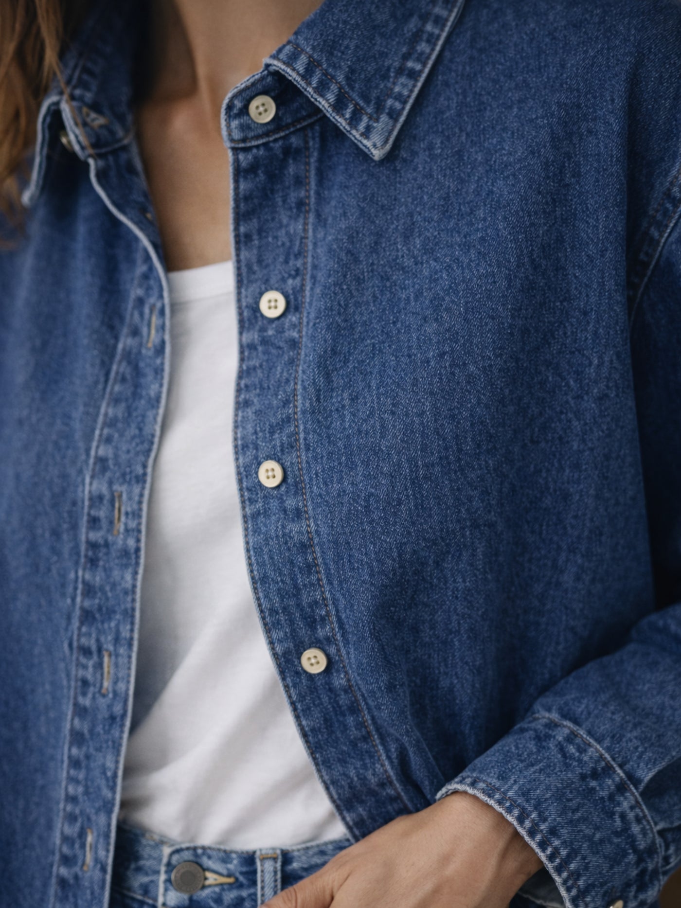 Dark blue oversized denim shirt knotted at the waist