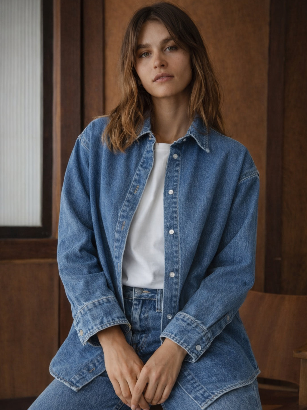 Front view of blue oversized denim shirt with spread collar
