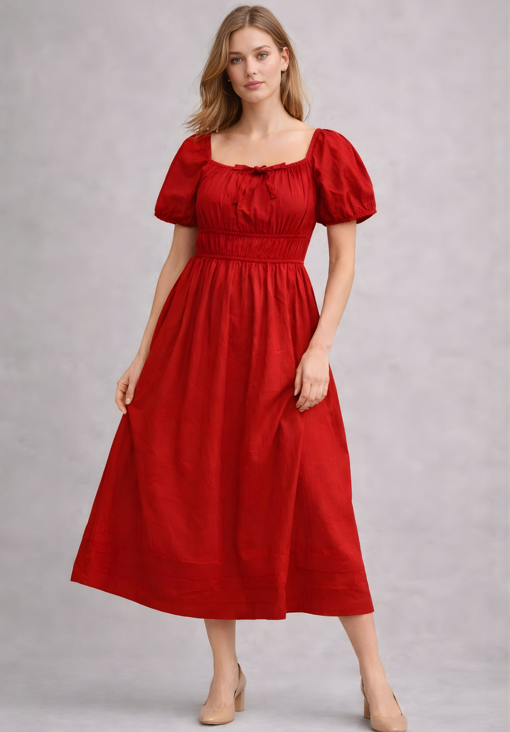 Side view of red cotton A-line dress showing smocked waist detail
